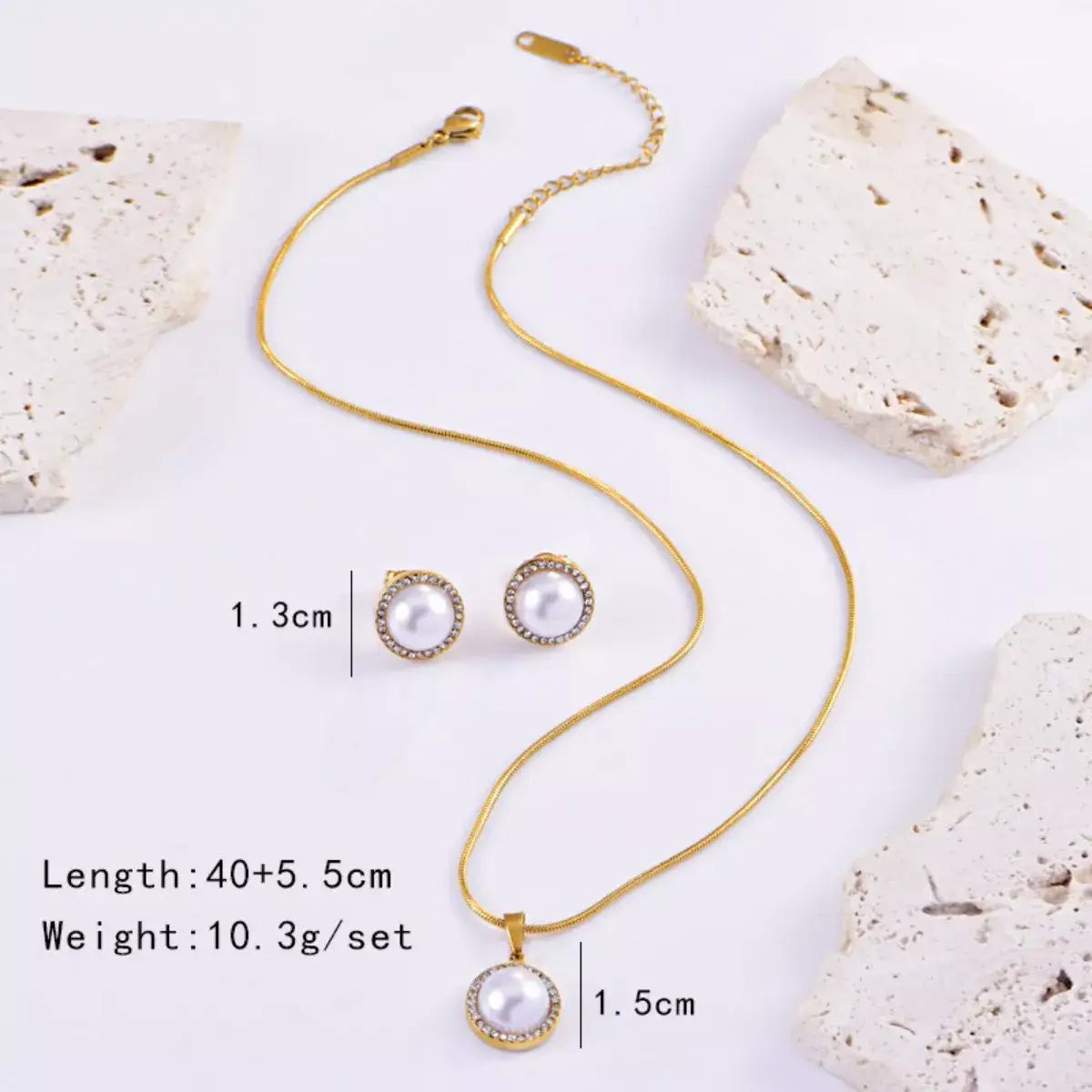 Evie's Dreamland 18K gold-plated pearl and rhinestone necklace and earring set on a white background.