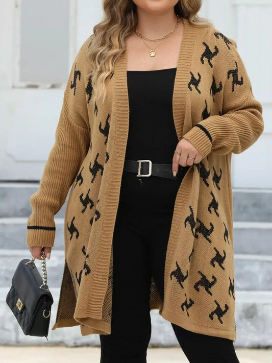 Woman wearing a long tan cardigan with black abstract patterns over a black outfit