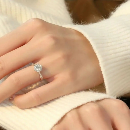 Moissanite 925 sterling silver ring by Evie's Dreamland on a hand wearing a white knit sweater.