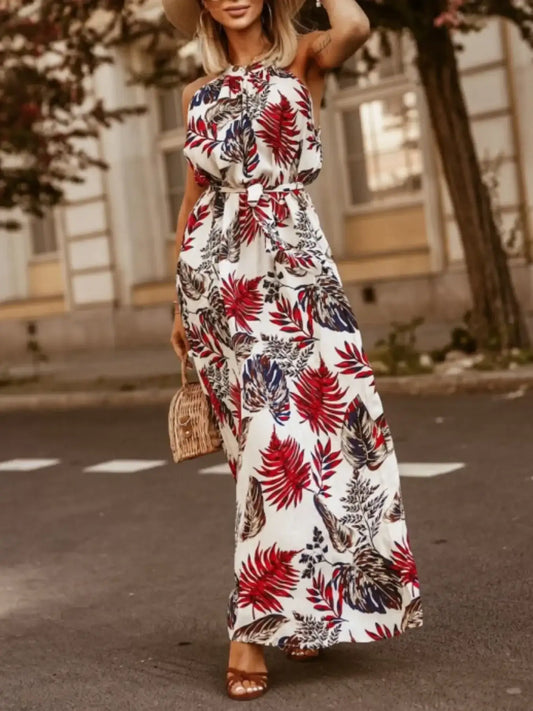Women's tropical floral halter dress with a tied neckline and flowing maxi-length skirt.