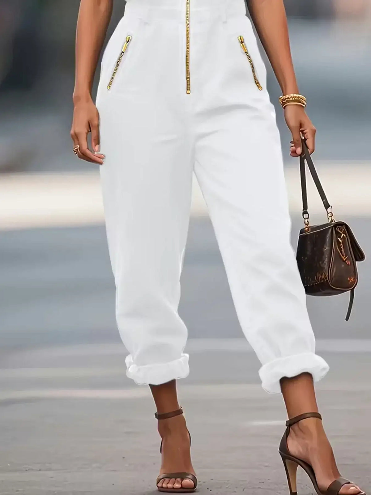 White sleeveless zip-up jumpsuit with gold zipper, front view