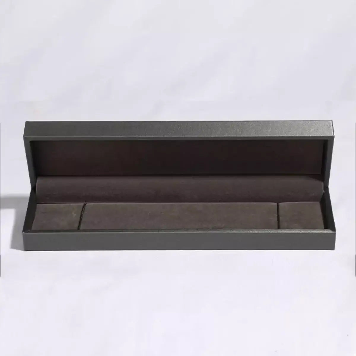 Open grey luxury jewelry gift box with plush grey interior lining by Trendsi.