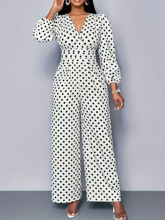 Woman wearing a white long-sleeve wide-leg jumpsuit with black polka dots