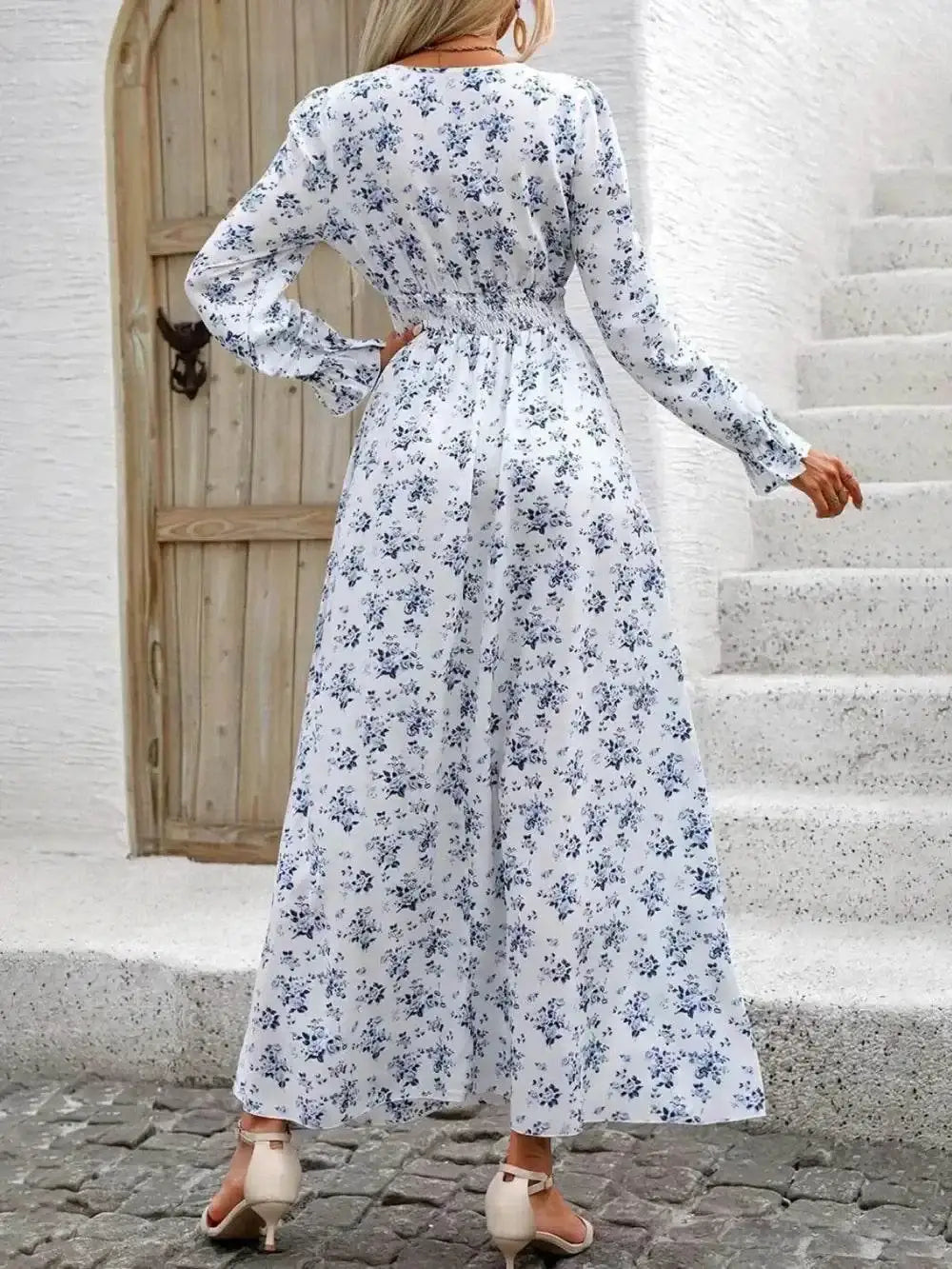 Woman wearing a smocked printed V-neck dress with flounce sleeves in feminine boho style
