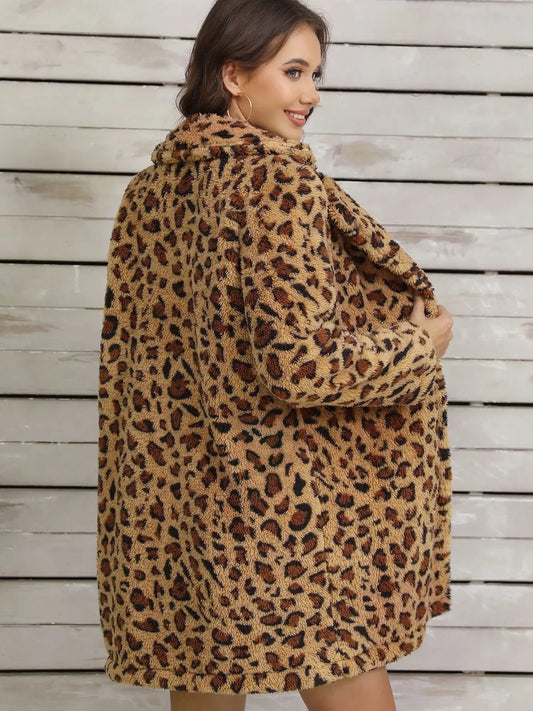 Young woman smiling wearing a fuzzy leopard print coat against a wooden panel background
