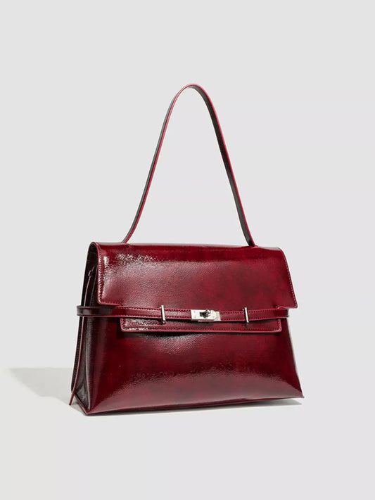 Evie's Dreamland medium burgundy PU leather shoulder bag with a glossy finish and silver buckle closure.