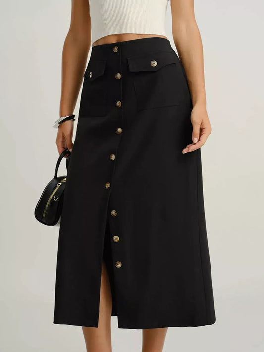 Woman wearing high-waisted black midi skirt with front buttons and flap pockets