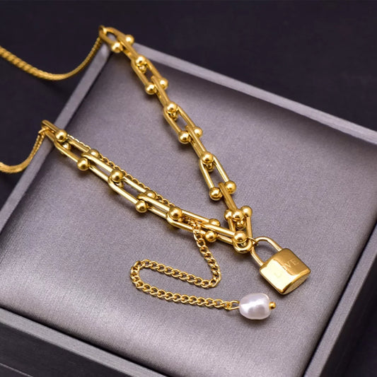 Gold chain necklace with lock pendant and pearl charm, elegant fashion jewelry for everyday wear