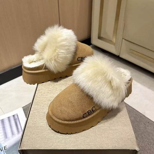 Tan platform slippers with fluffy faux fur trim and CBC embroidery on a box