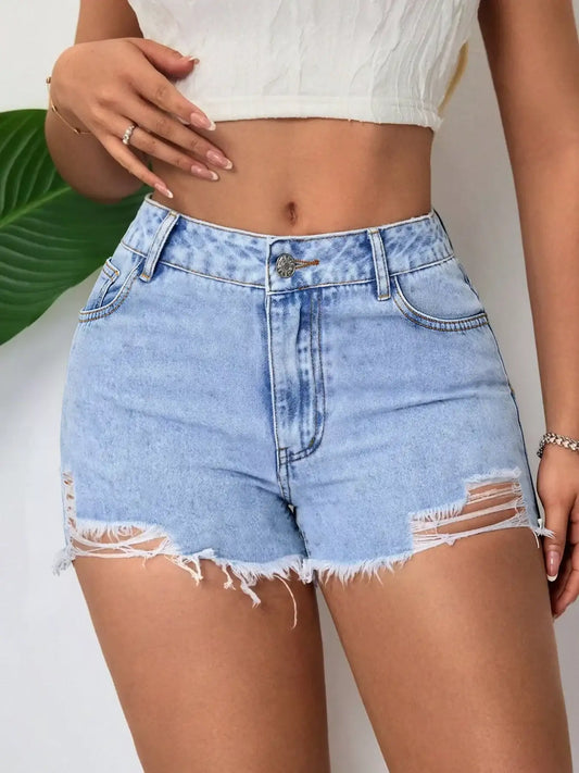 Woman wearing high-waisted light wash denim shorts with distressed frayed hems