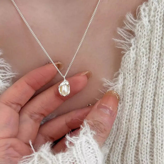Freshwater pearl 925 sterling silver necklace by Evie's Dreamland worn with a white knit sweater.