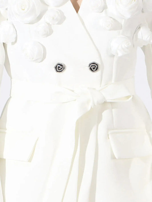 White double-breasted blazer by Evie's Dreamland with 3D flower appliqués and a tie waist.