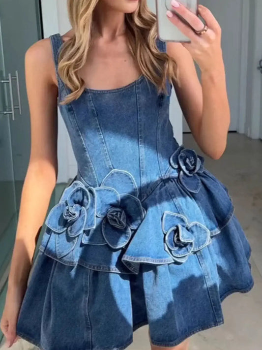 Woman wearing a stylish denim mini dress with floral appliqué details, sleeveless design