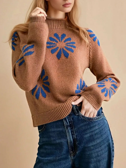 Brown Evie's Dreamland mock neck raglan sleeve sweater with blue floral patterns paired with blue jeans.