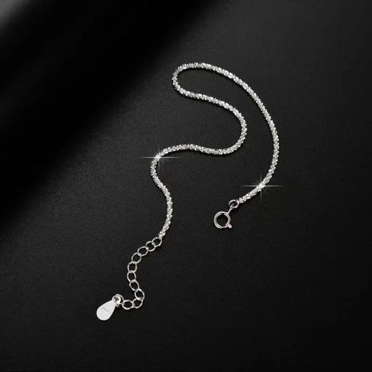 Evie's Dreamland 925 sterling silver adjustable chain bracelet with sparkling crystals on a black background.