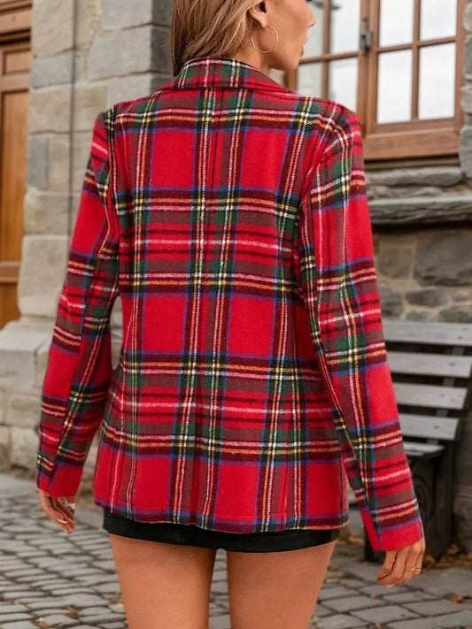 Back view of a woman wearing a red plaid oversized blazer and black skirt.