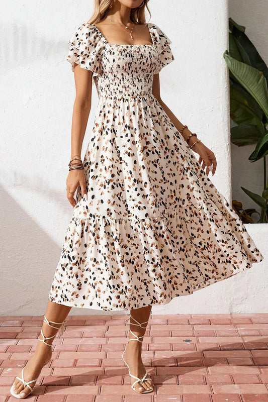 Floral midi dress with ruffle sleeves and smocked waist, perfect for summer elegance