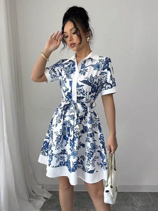 Blue and white floral print shirt dress with tie waist, paired with white chain bag for chic everyday style