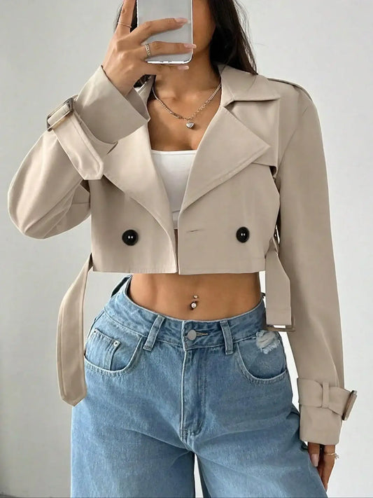 Women's beige cropped jacket with double-breasted buttons and lapel collar, paired with high-waist wide-leg jeans