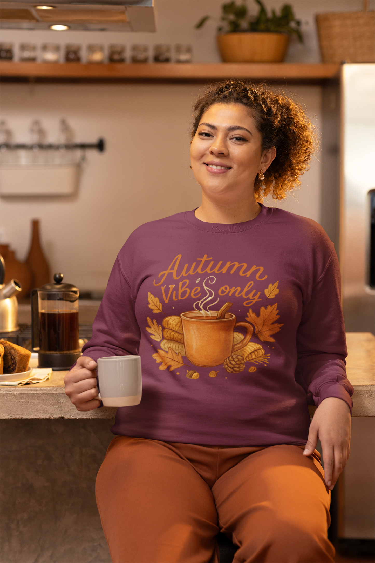Close-up of embroidered Autumn Vibes Only text on cozy crewneck sweatshirt