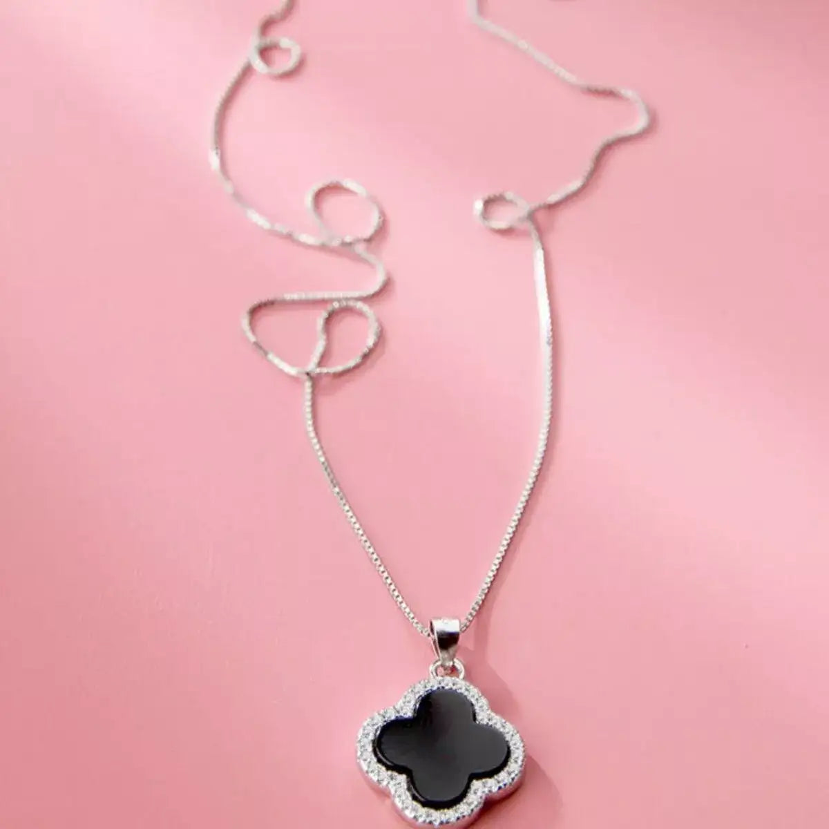 Evie's Dreamland 925 sterling silver clover pendant necklace with black center and sparkling crystals.