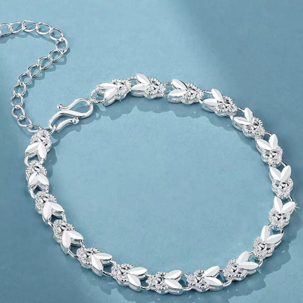 Evie's Dreamland 925 sterling silver chain bracelet with intricate leaf and floral patterns.