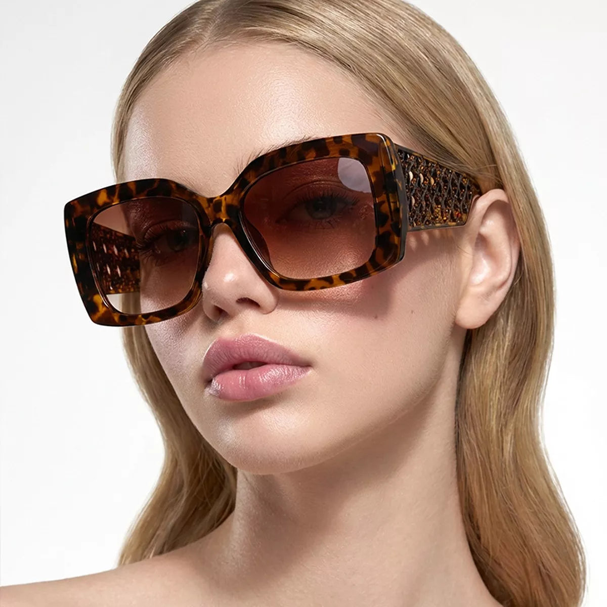 Woman wearing oversized square tortoiseshell sunglasses with gradient lenses
