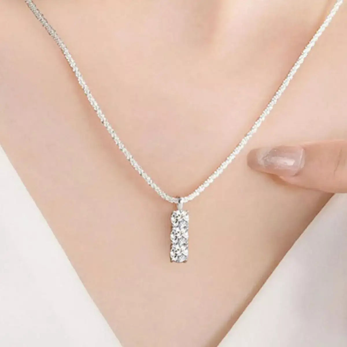 Evie's Dreamland Moissanite bar necklace in 925 sterling silver worn on a woman.