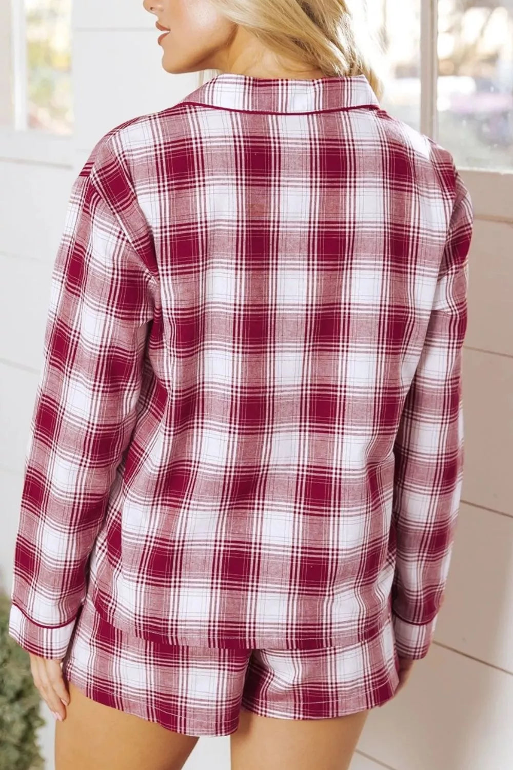 Woman wearing cozy red and white plaid long sleeve pajama top and shorts set