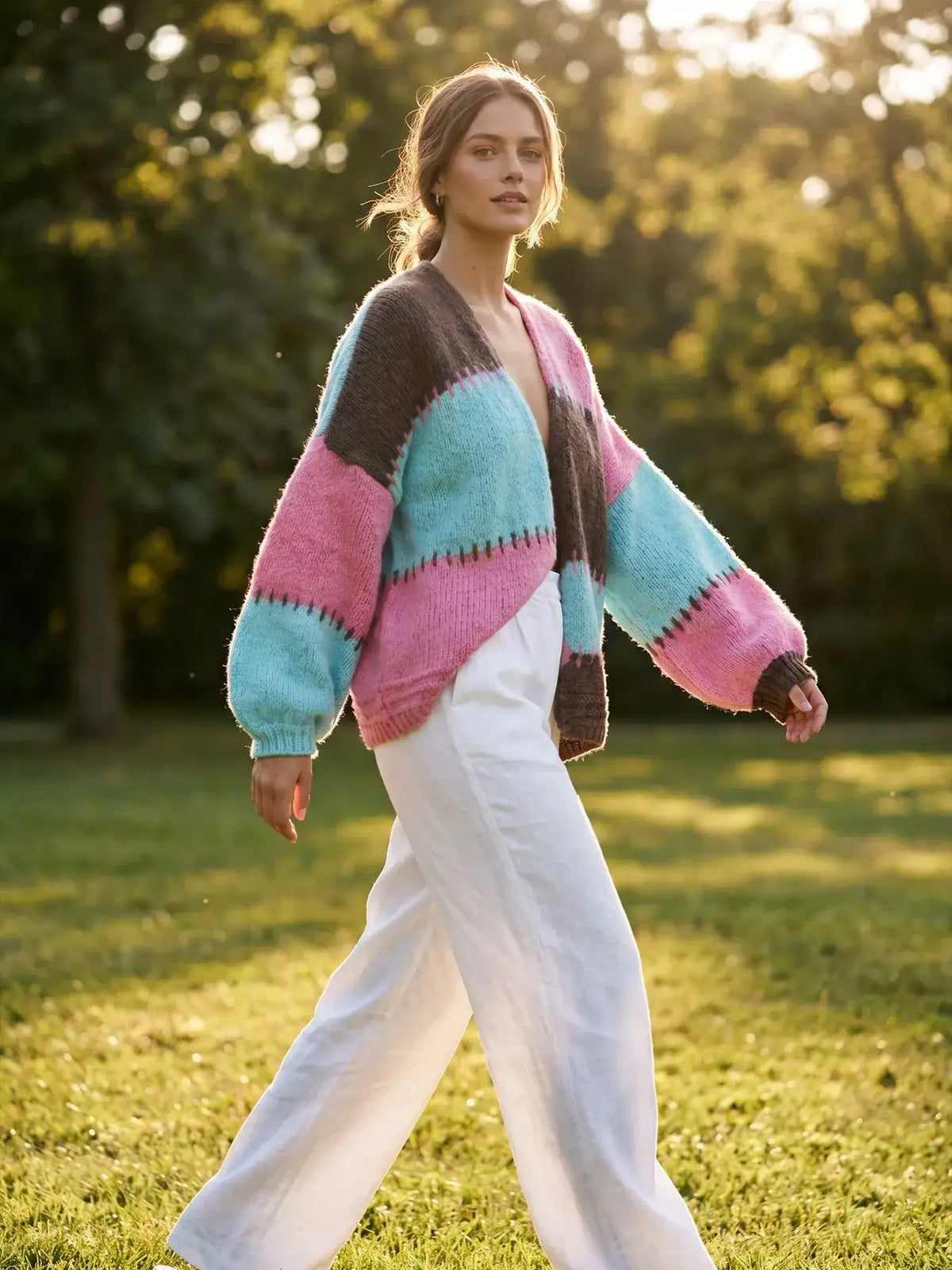 Evie's Dreamland color-block V-neck cardigan in pink, blue, and brown with white wide-leg trousers.