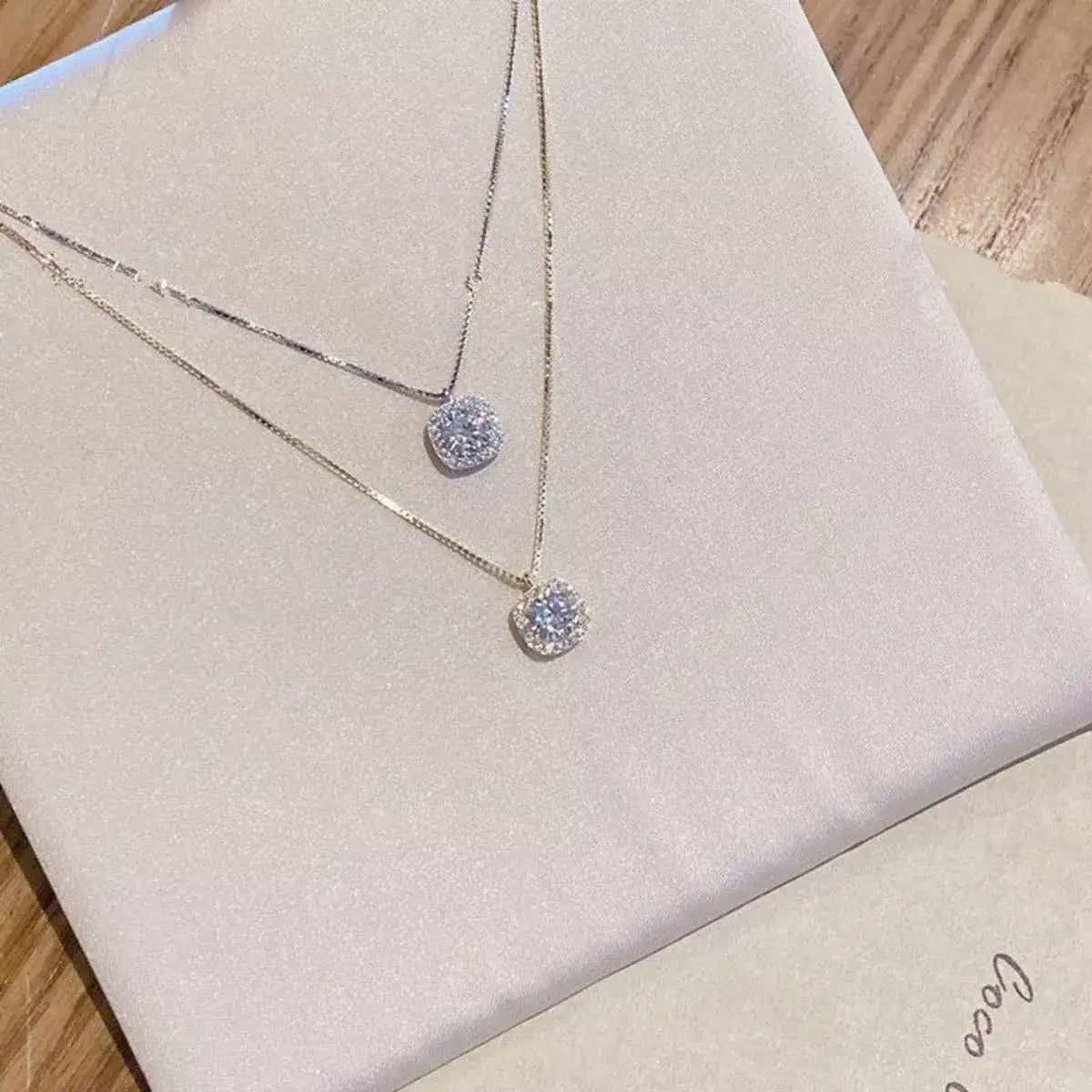 Layered 925 Sterling Silver Zircon pendant necklaces by Evie's Dreamland on a white display.