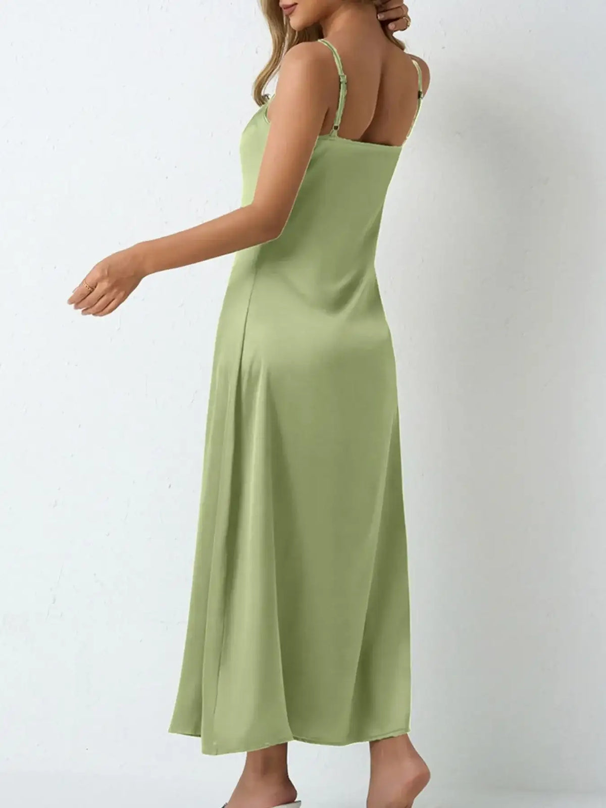 Back view of a light green satin cowl neck slip maxi dress by Evie's Dreamland with thin straps.