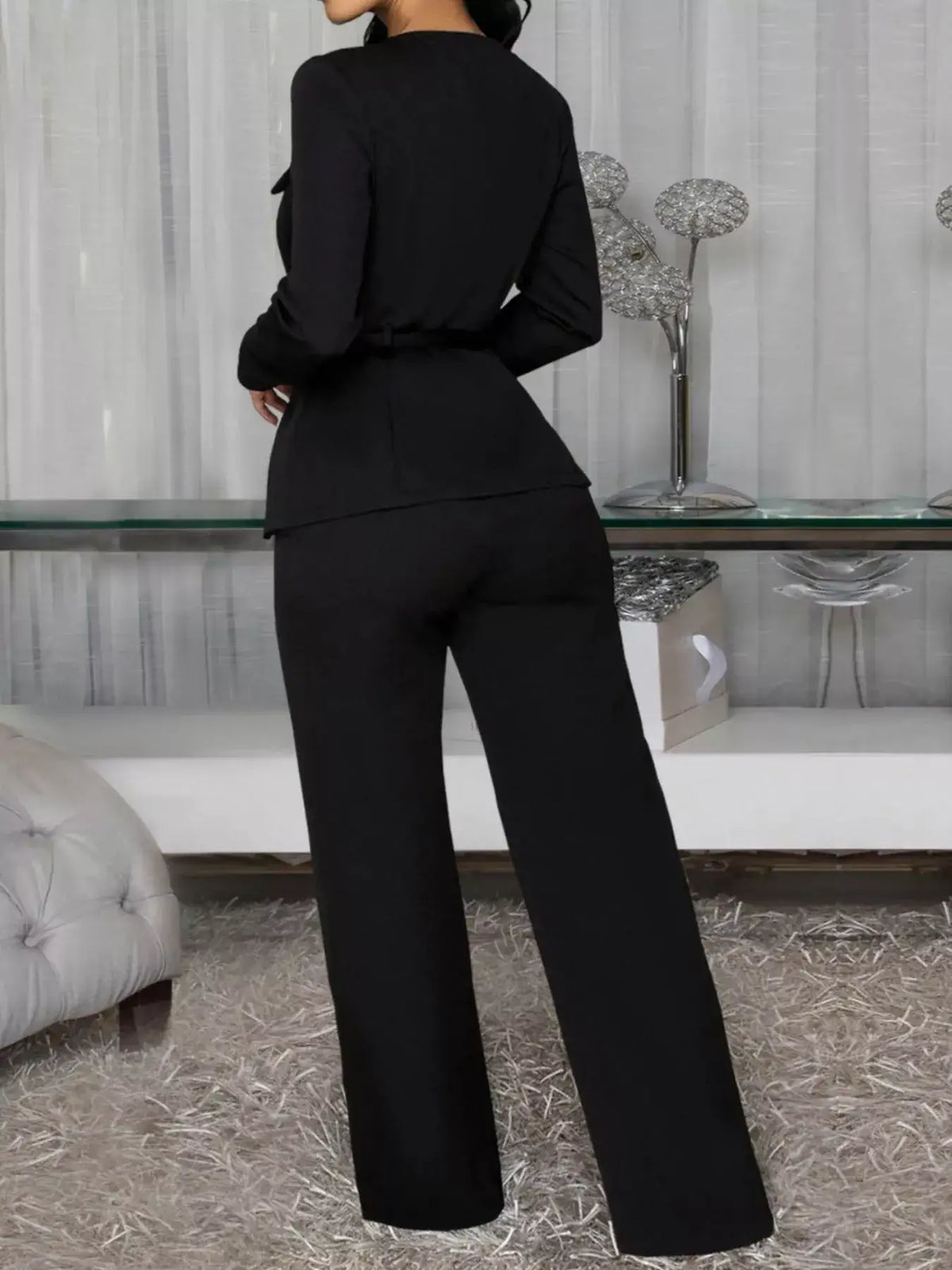 Back view of a black long sleeve button-up top and belted wide-leg pants set by Evie's Dreamland.