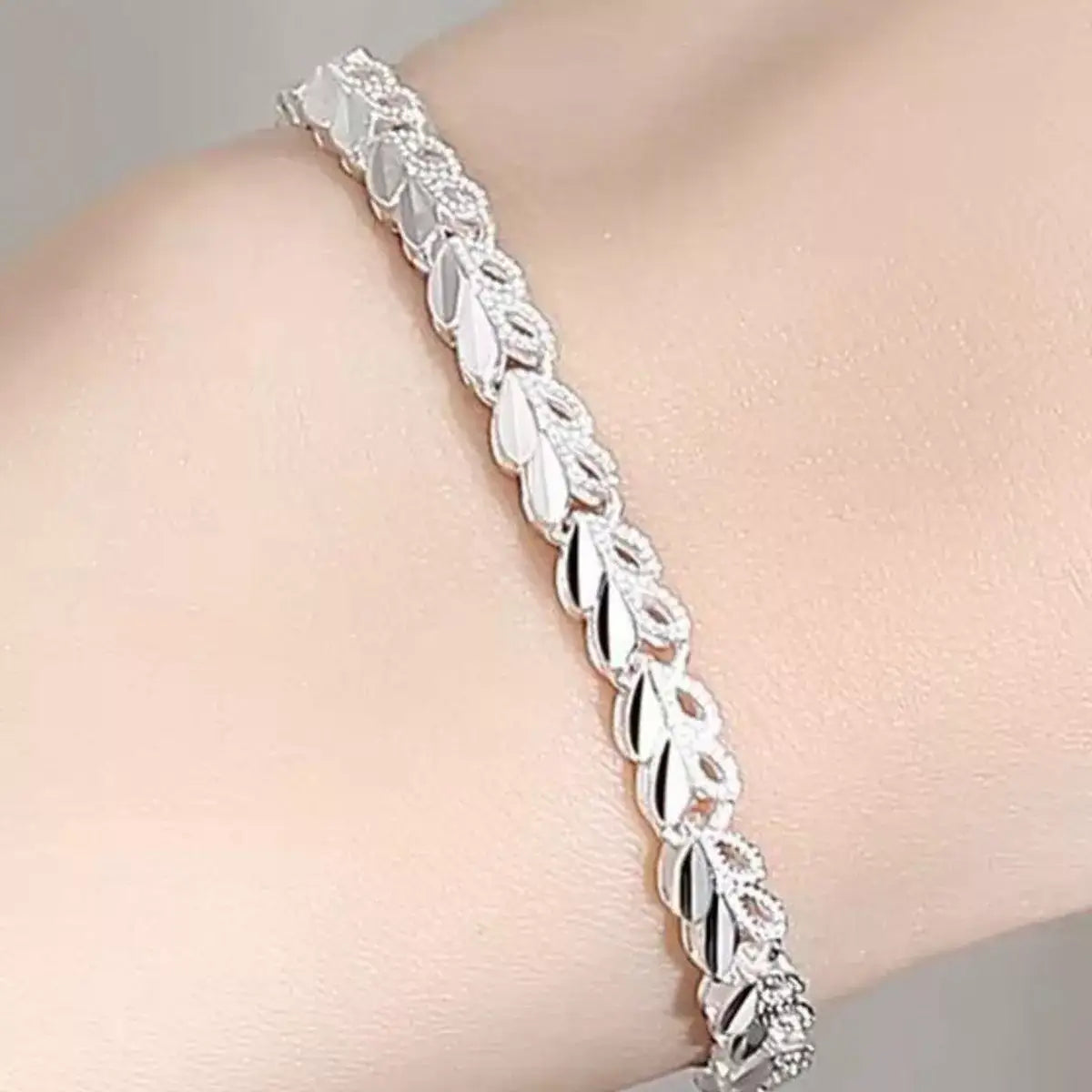 Trendsi 925 sterling silver heart link bracelet worn on a woman's wrist.