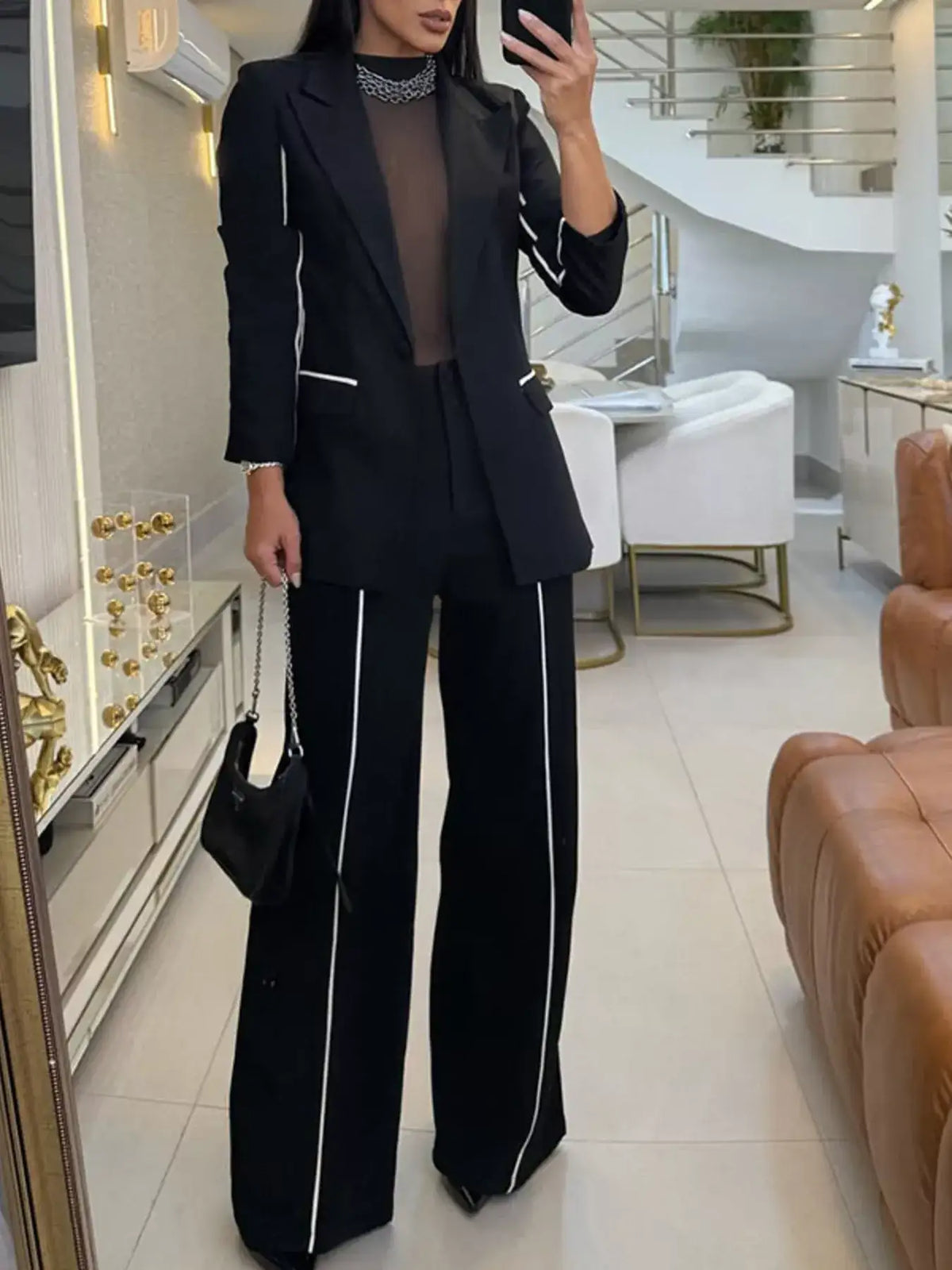 Evie's Dreamland black two-piece suit with white contrast trim, blazer and wide leg pants.