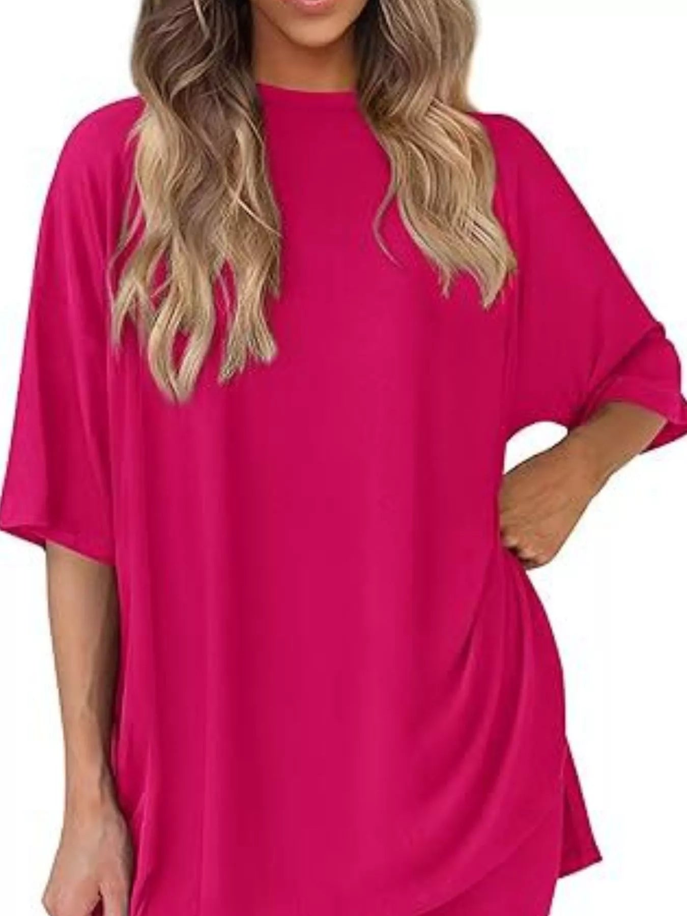 Woman wearing oversized hot pink t-shirt tunic with short sleeves, casual style