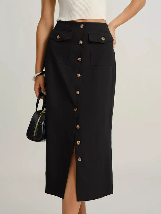 High-waisted black midi skirt with front buttons and flap pockets, styled with a white top