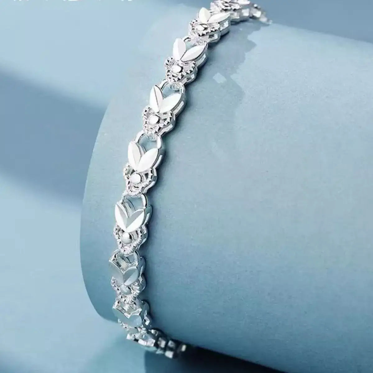 Evie's Dreamland 925 sterling silver chain bracelet with polished floral link details.
