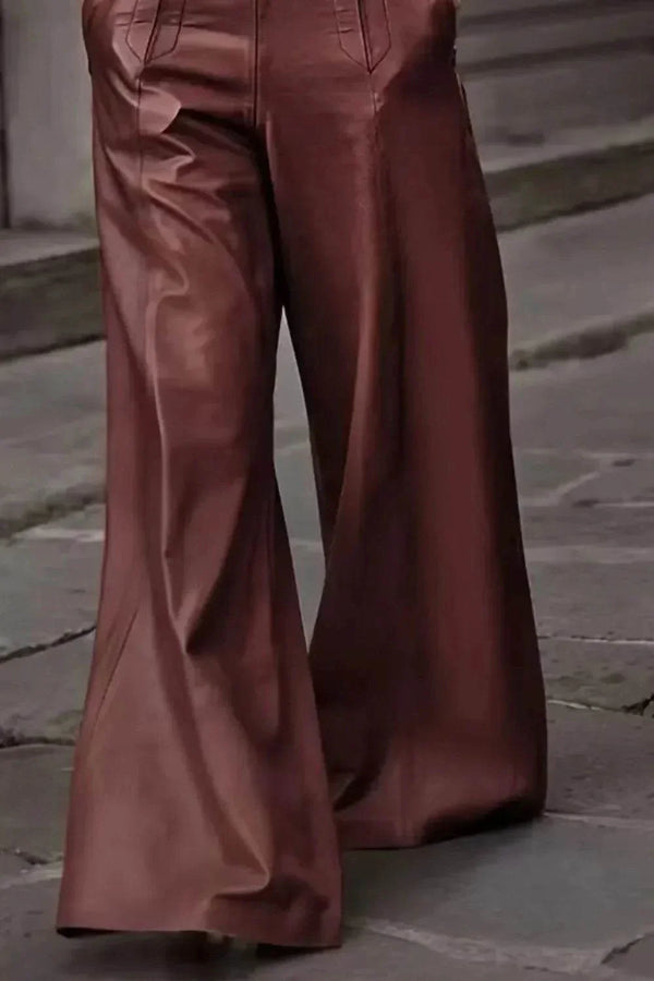 High-waisted brown leather wide-leg pants on cobblestone street background