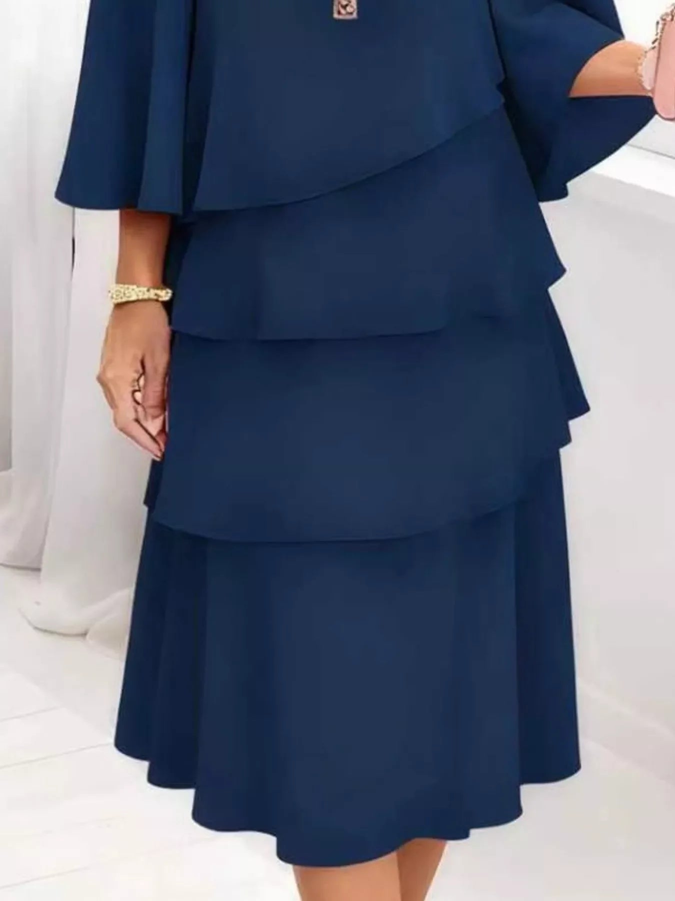 Navy blue tiered midi dress with flared sleeves, elegant for everyday wear