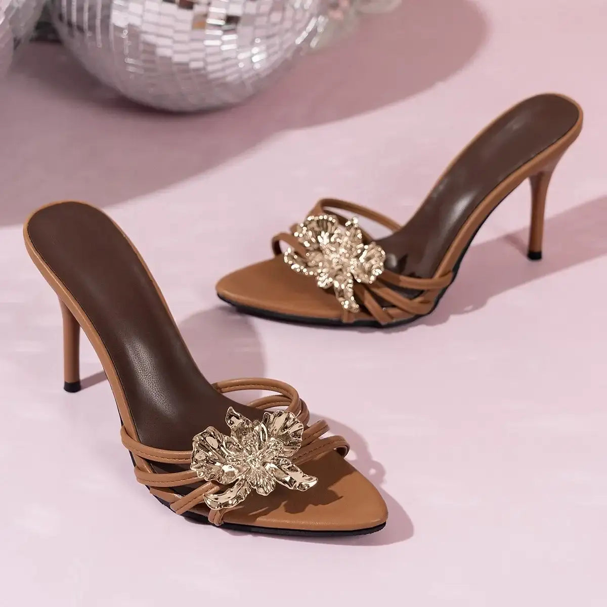 Brown open toe stiletto heeled sandals by Evie's Dreamland featuring gold floral embellishments.