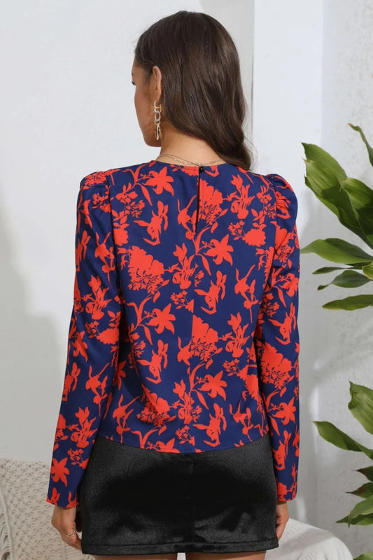 Navy blue floral print blouse with puff sleeves, back view, paired with black shorts for chic everyday style