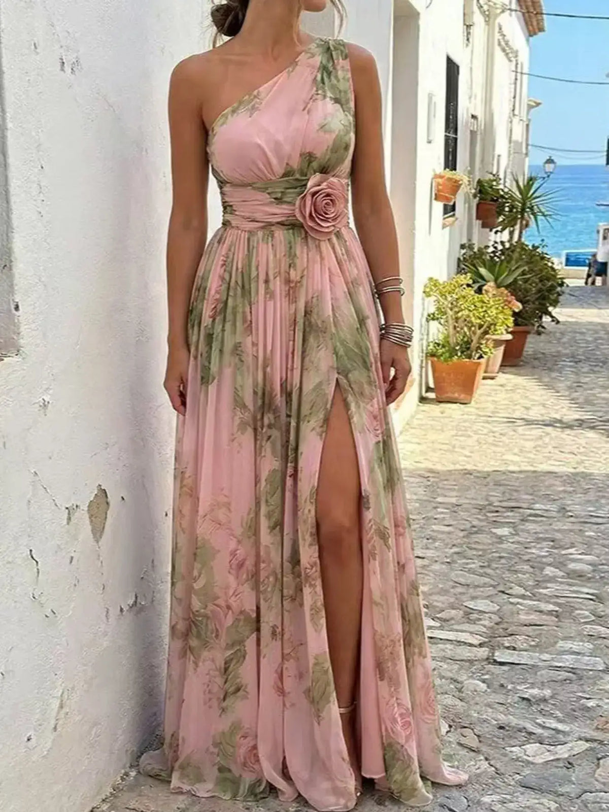 Evie's Dreamland pink one-shoulder floral chiffon maxi dress with a waist flower and high slit.