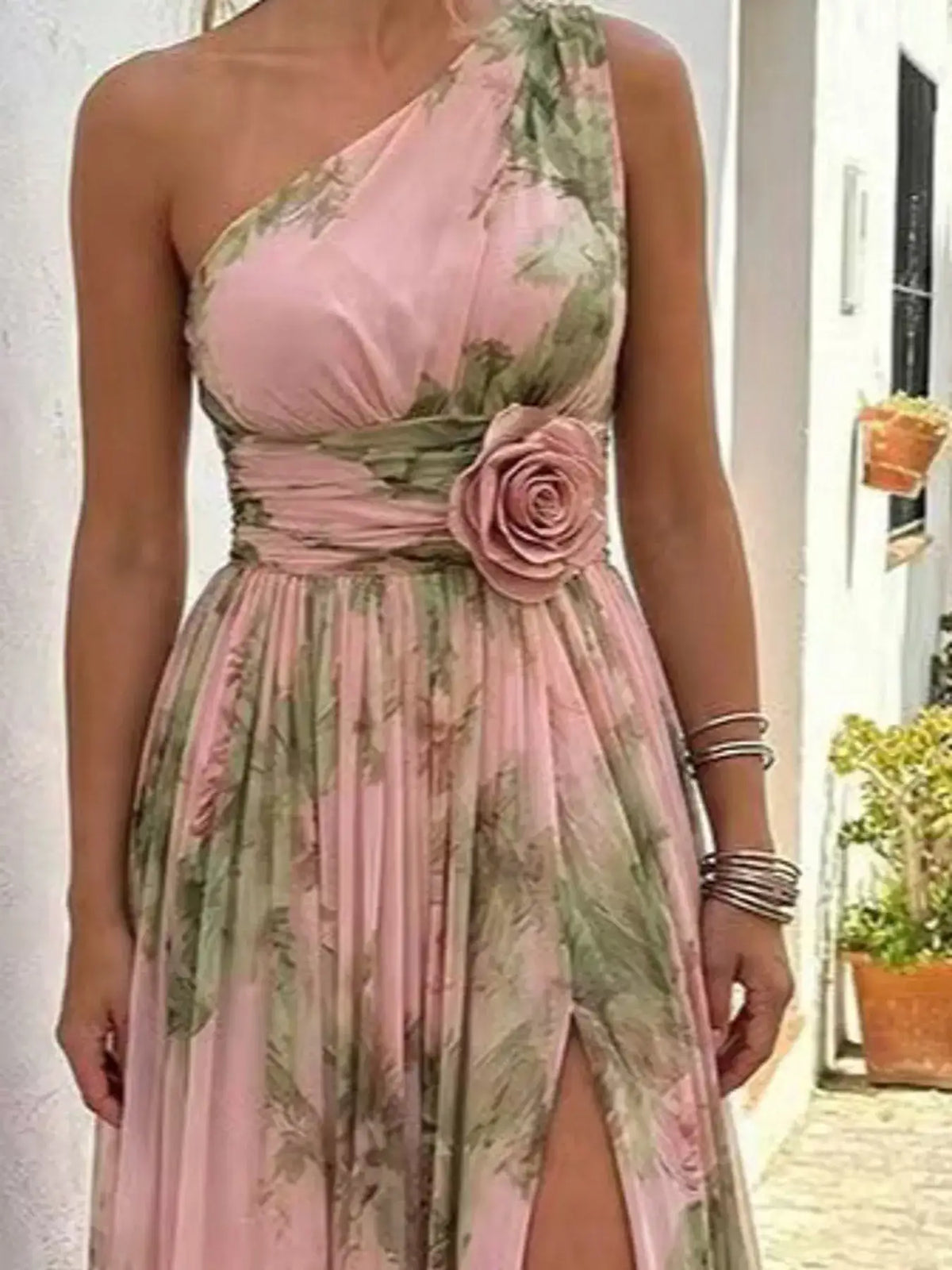 Evie's Dreamland pink one-shoulder floral chiffon maxi dress with a fabric rose detail at the waist.