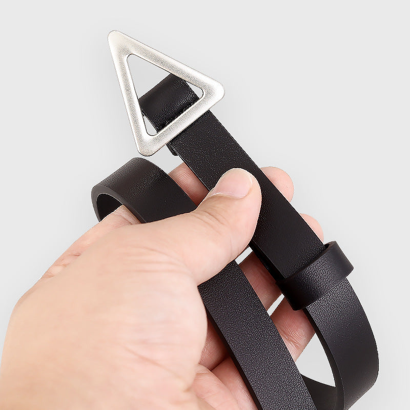 Close-up of a black leather belt with a silver triangular buckle held in a hand.