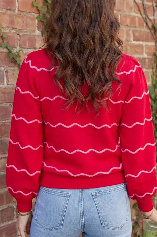 Back view of a red Evie's Dreamland long sleeve pullover sweater with pink wavy stripes and puff sleeves.