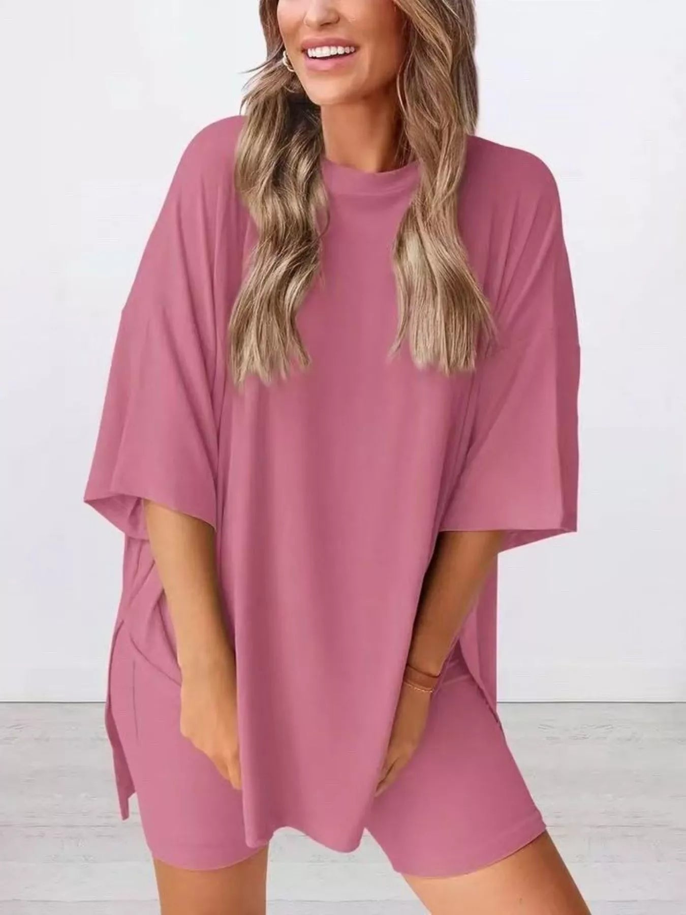 Woman wearing loose pink oversized t-shirt and matching biker shorts set