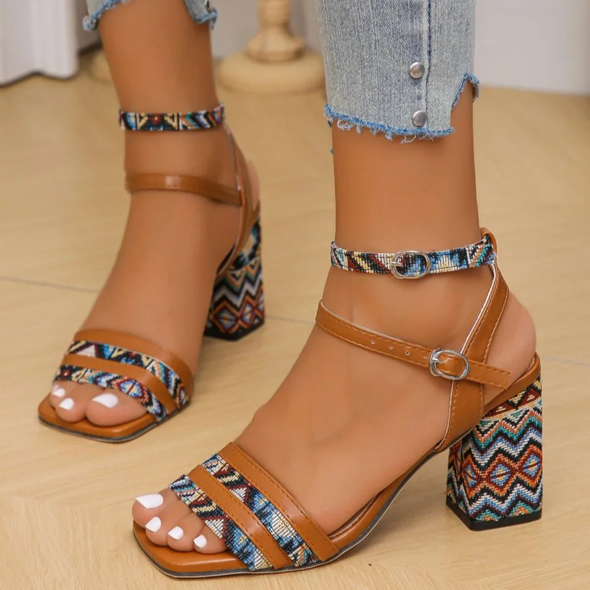 Pair of women's open toe light brown mid-heel sandals