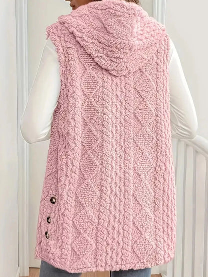 Back view of a woman wearing a pink textured hooded sleeveless knit vest with tortoiseshell buttons