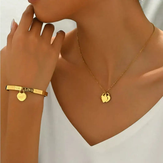 Evie's Dreamland 18K gold-plated heart pendant necklace and matching engraved cuff bracelet on a woman.